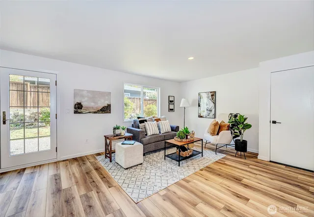 a living room with furniture and wooden floor