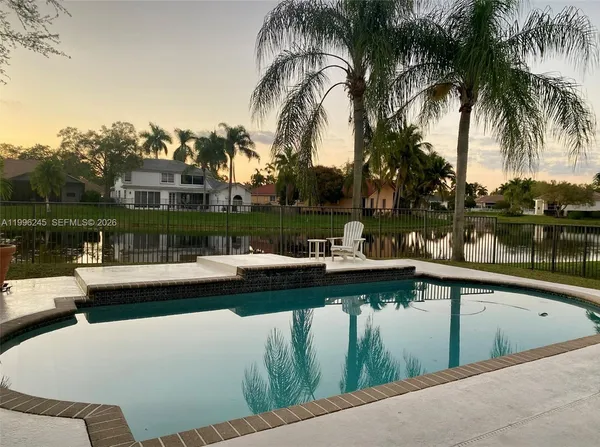 a view of swimming pool with outdoor seating and lake view