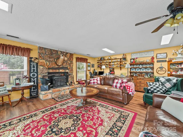a living room with furniture a rug and a floor to ceiling window