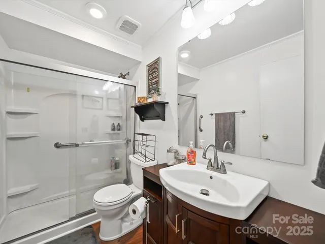 a bathroom with a sink toilet and shower