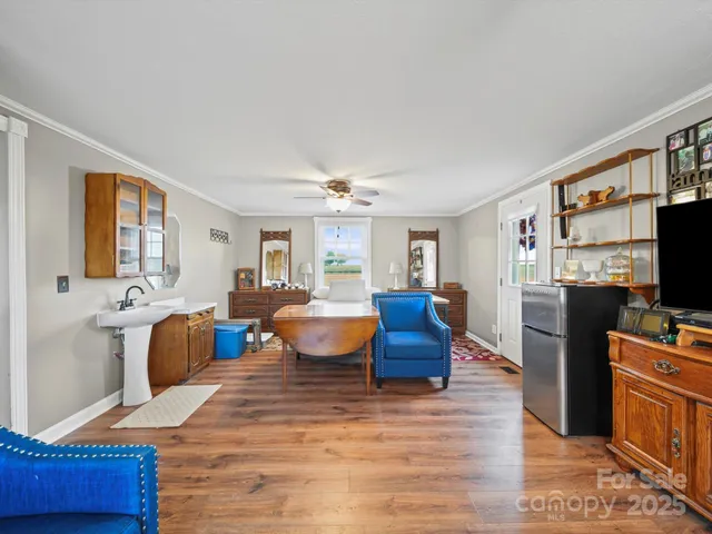 a living room with furniture a flat screen tv and large window