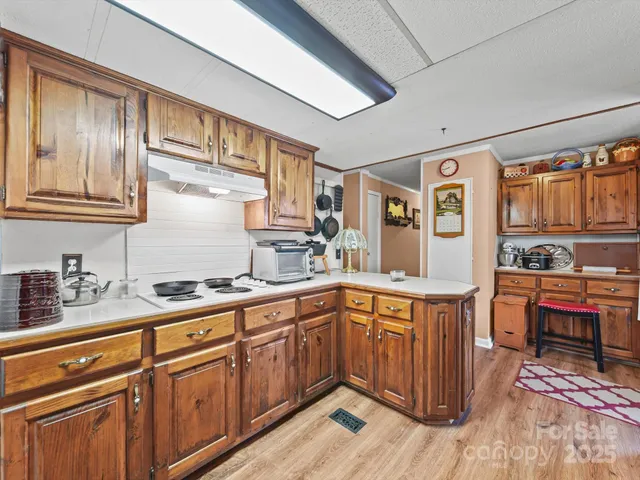 a kitchen with stainless steel appliances granite countertop a sink and wooden cabinets