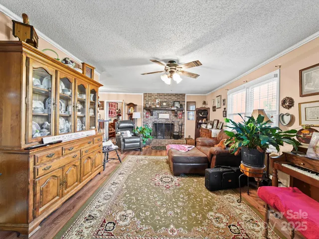 a living room with furniture fireplace and a large window