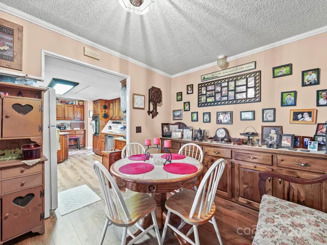 a dining room with furniture and wooden floor
