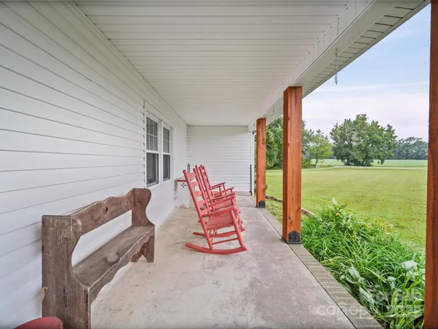 a building outdoor space with patio furniture and garden