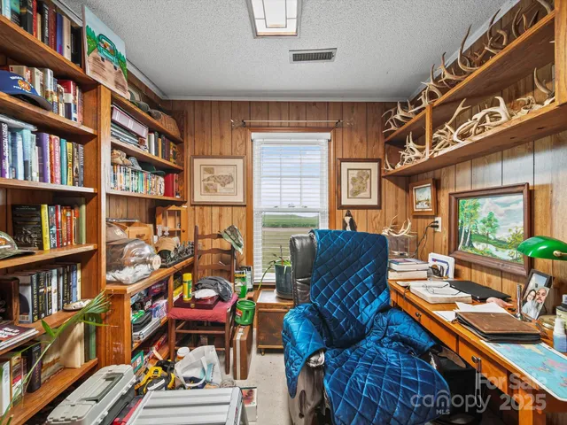 a couch sitting in a living room next to a book shelf