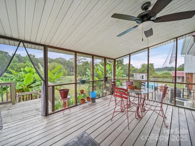 a view of a patio with a table chairs and wooden floor