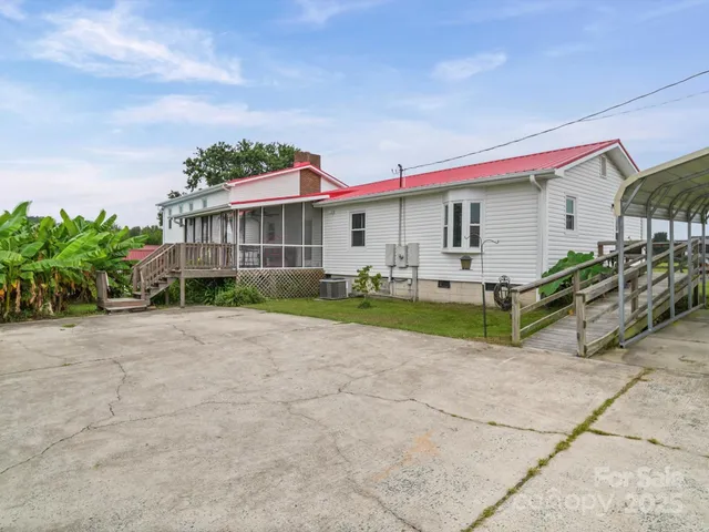 a view of a house with a backyard and plants