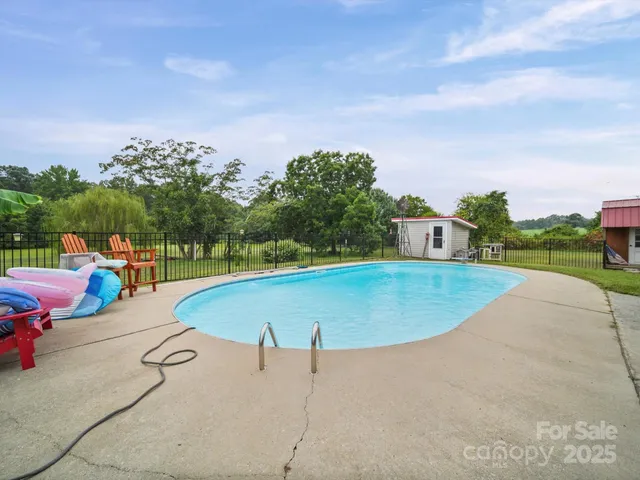 a view of a swimming pool and a yard
