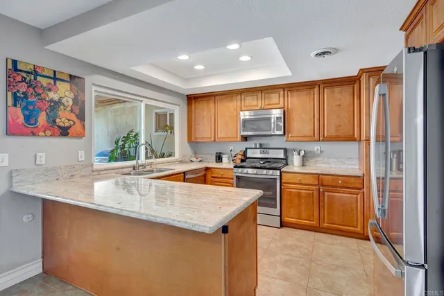 a kitchen with stainless steel appliances granite countertop a sink stove and cabinets