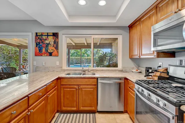 a kitchen with a sink stove top oven and cabinets