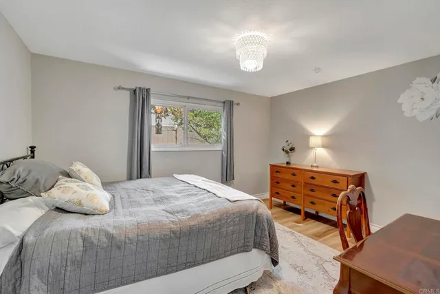 a bedroom with a bed and a chandelier