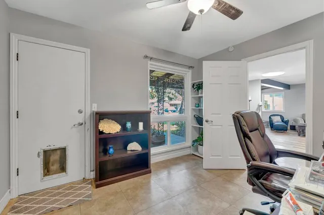 a view of a workspace with furniture and a window