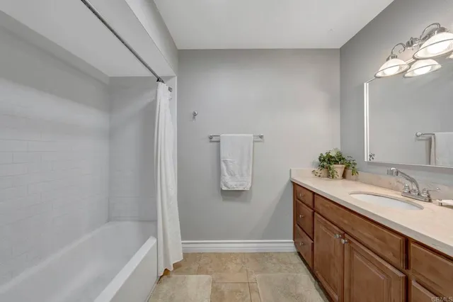 a bathroom with a tub sink and mirror