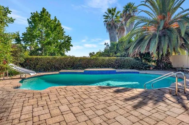 a green field with some trees in the background