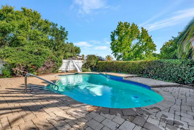 a view of a swimming pool with a patio