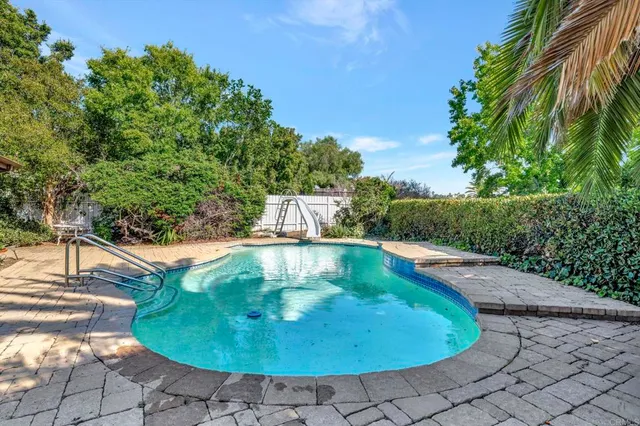 a view of a swimming pool with a yard