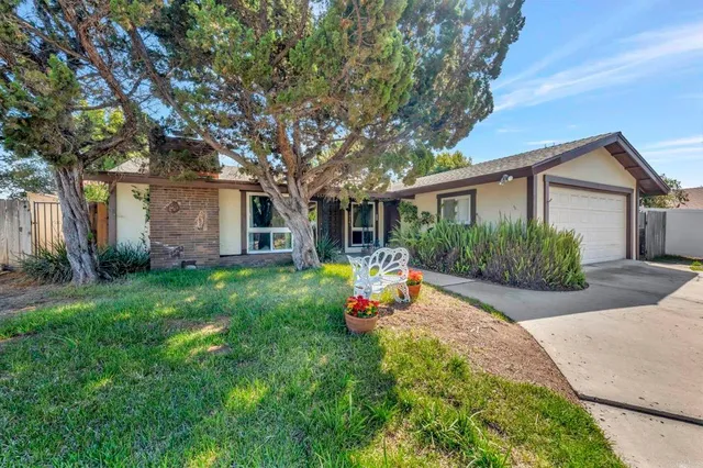 a front view of house with yard and outdoor seating