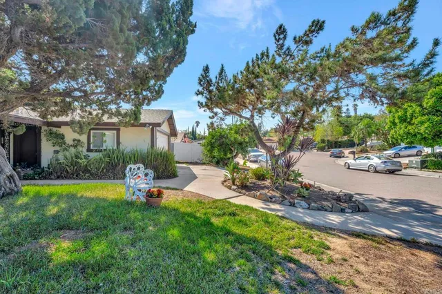 a view of a house with backyard and sitting area
