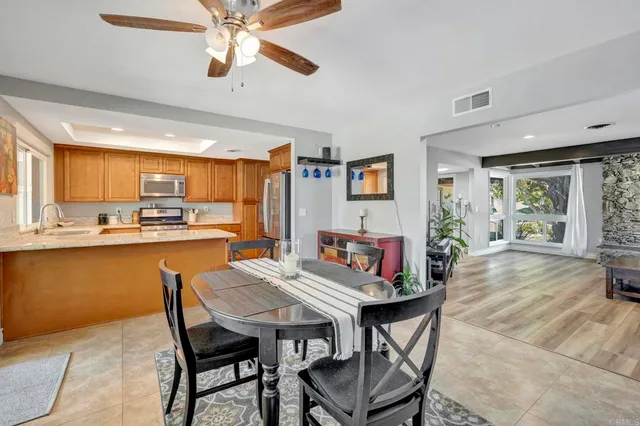a view of a dining room with furniture and a kitchen
