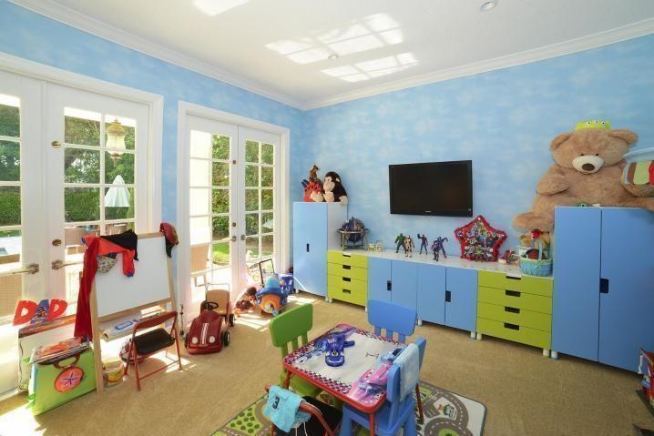 6167 Northwest 23rd Way Boca Raton, FL 33496 - Photo 12 of 28 a bed room with furniture and a flat screen tv