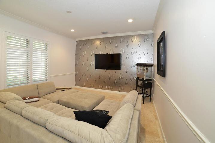 6167 Northwest 23rd Way Boca Raton, FL 33496 - Photo 14 of 28 a living room with furniture and a flat screen tv