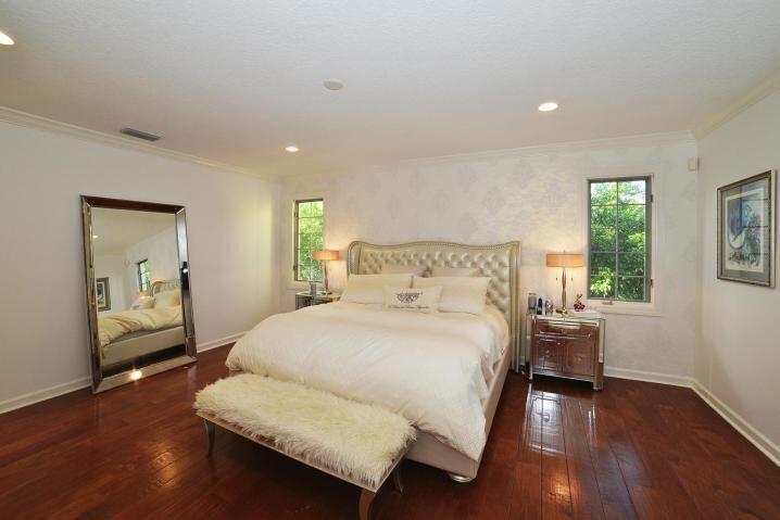 6167 Northwest 23rd Way Boca Raton, FL 33496 - Photo 18 of 28 a bedroom with a bed and wooden floor