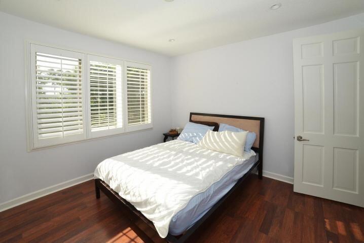 6167 Northwest 23rd Way Boca Raton, FL 33496 - Photo 22 of 28 a large bed sitting in a bedroom next to a window