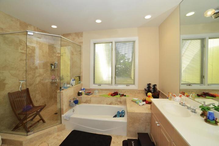 6167 Northwest 23rd Way Boca Raton, FL 33496 - Photo 24 of 28 a bathroom with a tub sink and mirror