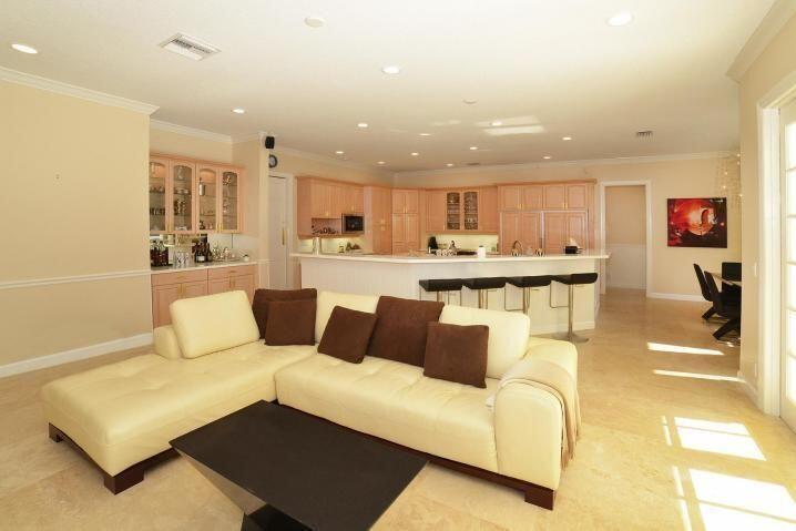 6167 Northwest 23rd Way Boca Raton, FL 33496 - Photo 4 of 28 a living room with stainless steel appliances furniture a rug and a kitchen view