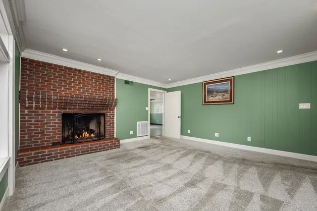a view of an empty room with a fireplace