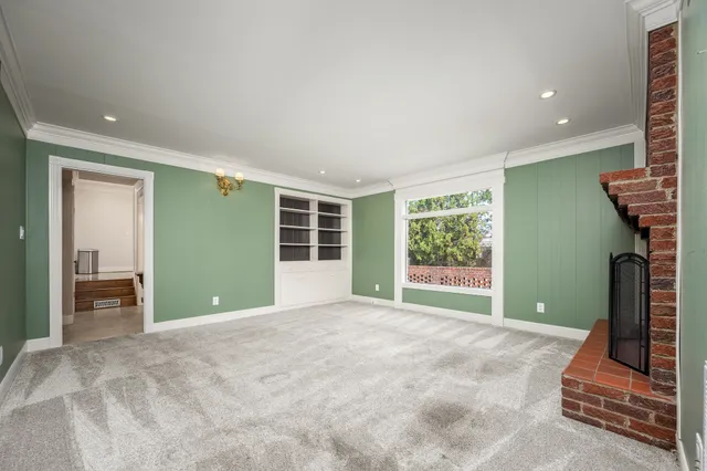 a view of a room with a large bed and a window