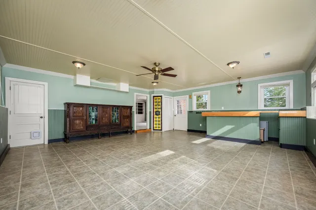 a view of an empty room with a fireplace and a window