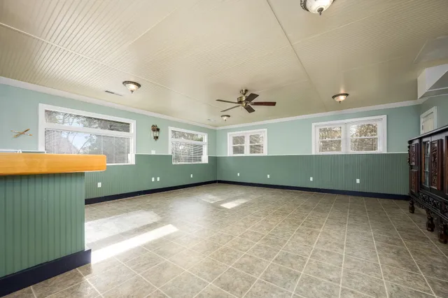 a view of a room with gym equipment and windows