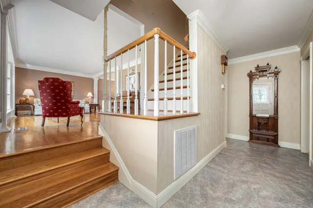 a view of entryway and hall with wooden floor