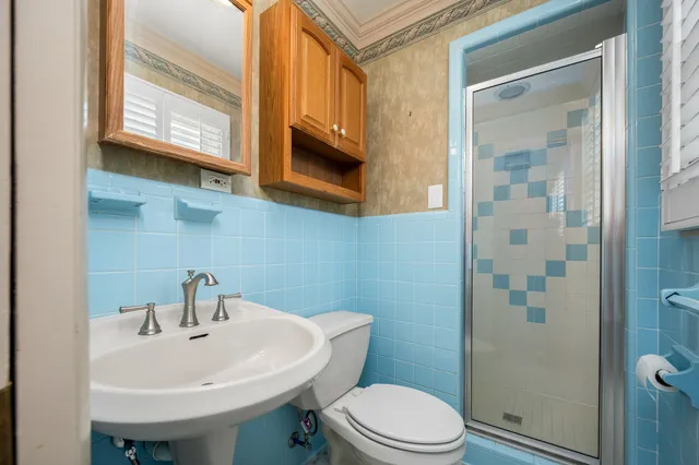 a bathroom with a sink a mirror and a toilet