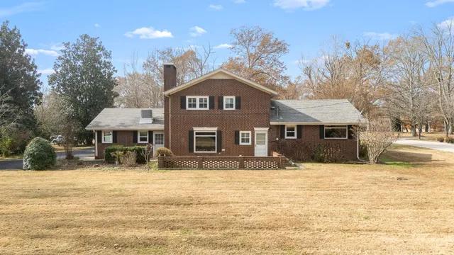 a front view of a house with a yard covered with snow in front of house