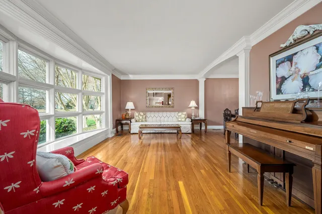 a living room with furniture and large windows