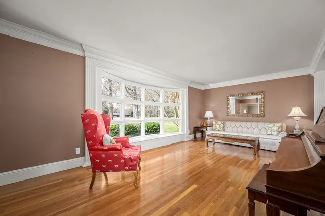 a living room with furniture a table and a large window