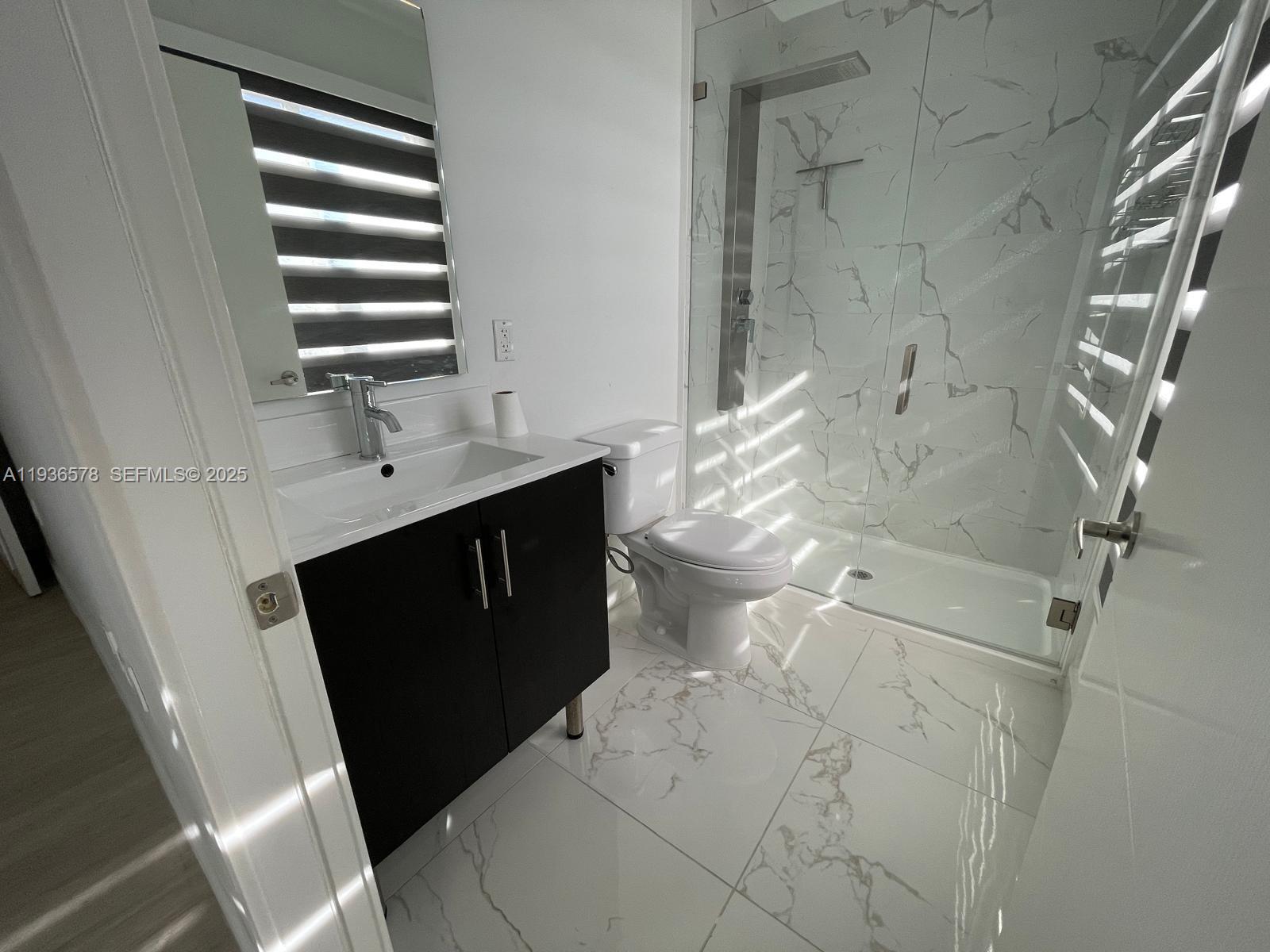 25869 Southwest 139th Court Homestead, FL 33032 - Photo 14 of 22 a bathroom with a sink vanity and a mirror