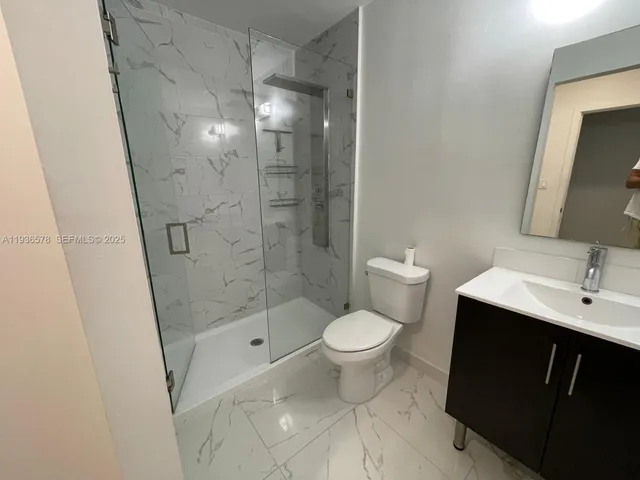 an empty room with wooden floor and closet