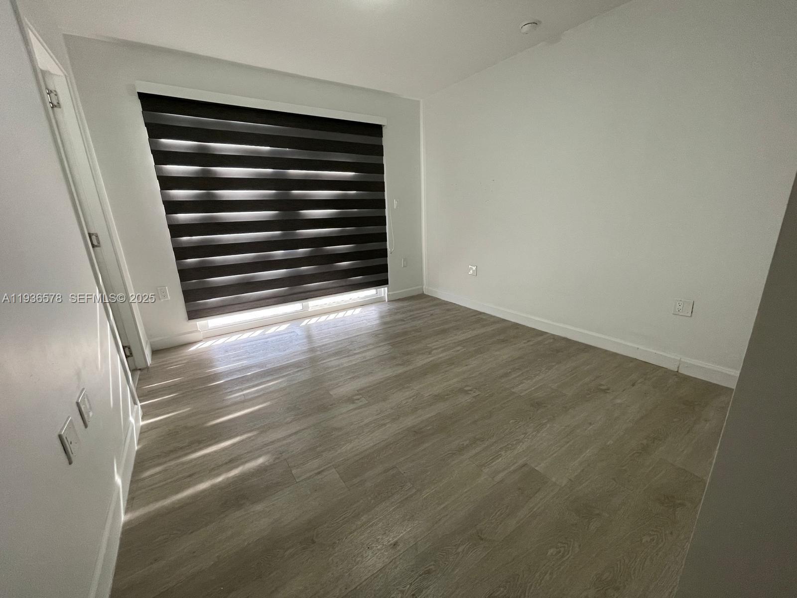 25869 Southwest 139th Court Homestead, FL 33032 - Photo 21 of 22 a view of empty room with wooden floor