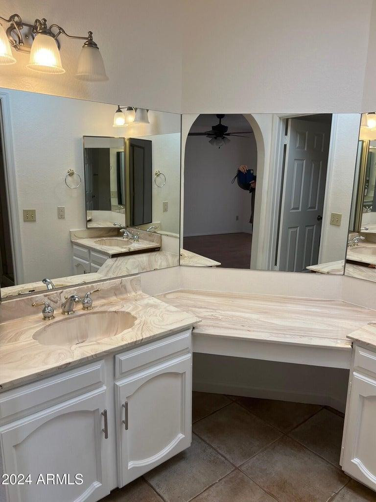 16623 North 29th Drive Phoenix, AZ 85053 - Photo 6 of 13 a bathroom with a sink and a mirror