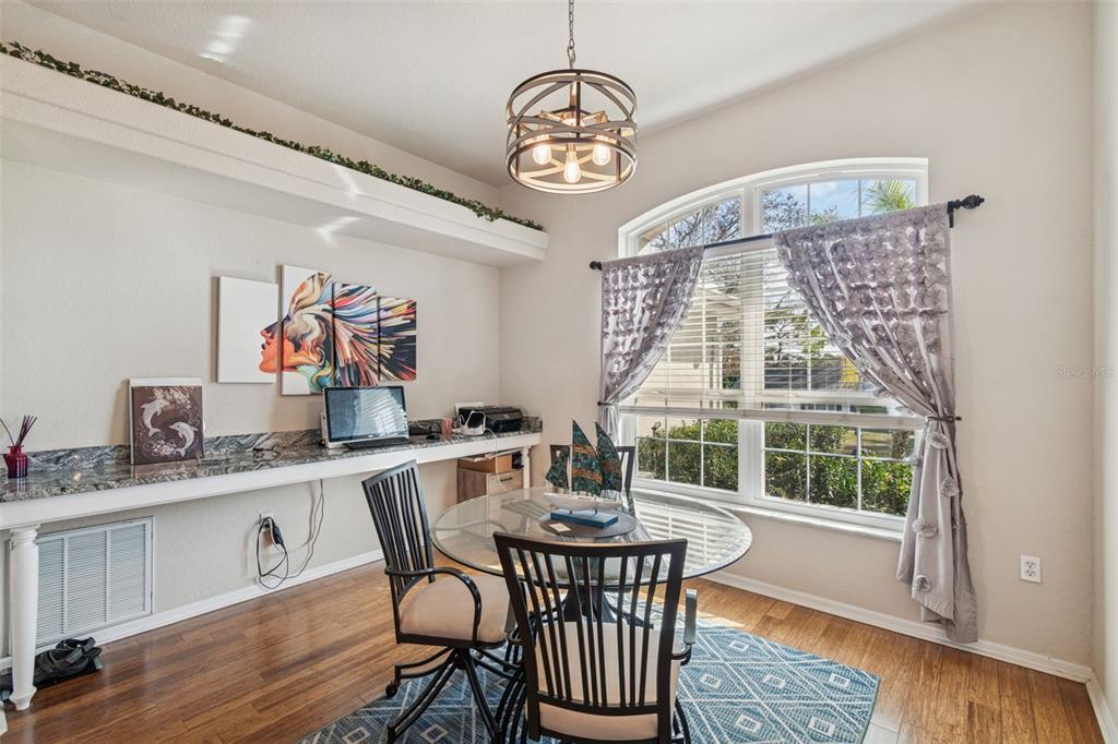 5287 Slater Road Spring Hill, FL 34608 - Photo 16 of 86 a view of a dining room with furniture wooden floor and a chandelier