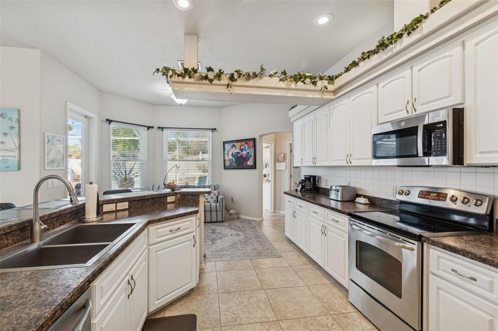 5287 Slater Road Spring Hill, FL 34608 - Photo 23 of 86 a kitchen with stainless steel appliances granite countertop a sink stove and cabinets