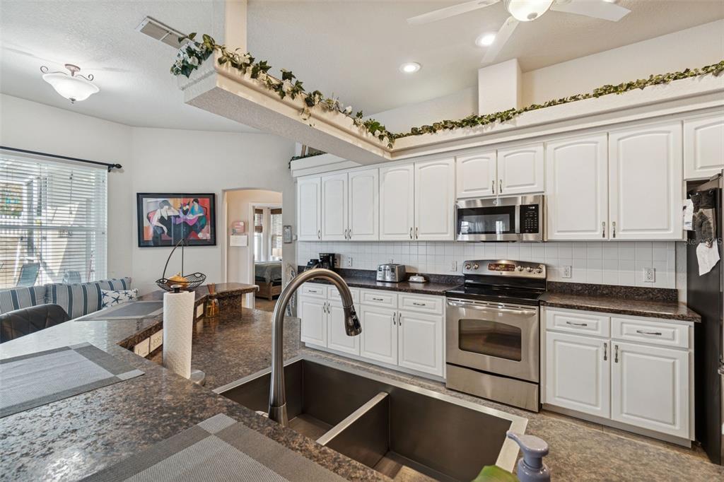 5287 Slater Road Spring Hill, FL 34608 - Photo 24 of 86 a kitchen with stainless steel appliances granite countertop a stove sink and cabinets