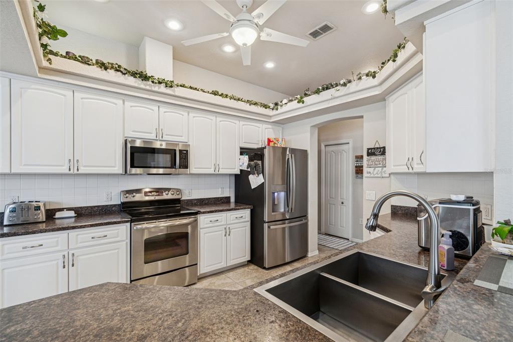 5287 Slater Road Spring Hill, FL 34608 - Photo 25 of 86 a kitchen with stainless steel appliances granite countertop a sink and a stove