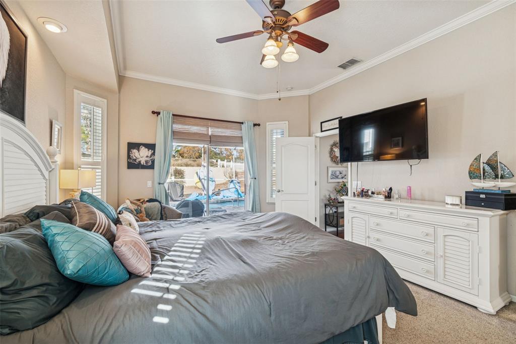 5287 Slater Road Spring Hill, FL 34608 - Photo 29 of 86 a bedroom with a bed and a flat screen tv