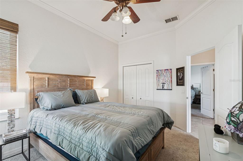 5287 Slater Road Spring Hill, FL 34608 - Photo 42 of 86 a bedroom with a bed and a chandelier