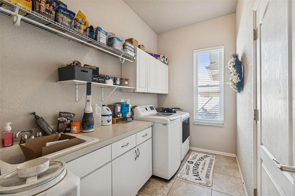 5287 Slater Road Spring Hill, FL 34608 - Photo 46 of 86 a kitchen with stainless steel appliances granite countertop a sink a stove and a refrigerator